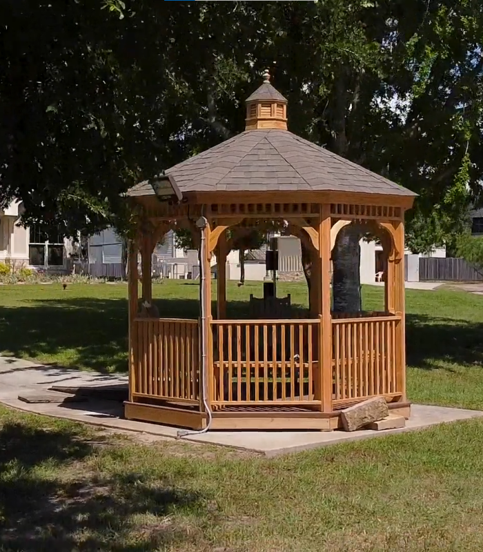 Wooden gazebo in a grassy outdoor area